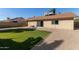 Artificial turf backyard with a view of the home's back at 6207 W Acoma Dr, Glendale, AZ 85306