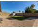 Landscaped backyard with artificial turf and storage shed at 6207 W Acoma Dr, Glendale, AZ 85306