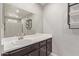 Bathroom with dark vanity, mirror and shower at 6207 W Acoma Dr, Glendale, AZ 85306