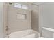 Clean bathroom with a tub, shower, and decorative tile at 6207 W Acoma Dr, Glendale, AZ 85306