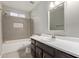 Modern bathroom with dark vanity, white countertop, and new fixtures at 6207 W Acoma Dr, Glendale, AZ 85306