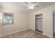 Well-lit bedroom featuring laminate floors and a large closet at 6207 W Acoma Dr, Glendale, AZ 85306