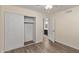 Bright bedroom with laminate flooring and mirrored closet doors at 6207 W Acoma Dr, Glendale, AZ 85306