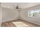 Bright bedroom with ceiling fan, window, and laminate wood floor at 6207 W Acoma Dr, Glendale, AZ 85306