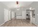 Open concept dining area with wood-look floors and white cabinets at 6207 W Acoma Dr, Glendale, AZ 85306