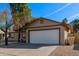 House exterior showcasing a white garage door and mature tree at 6207 W Acoma Dr, Glendale, AZ 85306