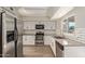 Updated kitchen featuring white shaker cabinets and stainless steel appliances at 6207 W Acoma Dr, Glendale, AZ 85306