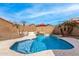 Inviting backyard oasis with a sparkling pool and waterfall feature at 6538 W Nez Perce St, Phoenix, AZ 85043