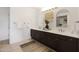 Elegant bathroom with double sinks and dark brown cabinetry at 7687 E Wing Shadow Rd, Scottsdale, AZ 85255