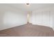 Simple bedroom with neutral carpeting and double doors to a hallway at 7687 E Wing Shadow Rd, Scottsdale, AZ 85255