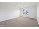 Spacious bedroom with neutral wall paint and carpet, plus a window with shutters at 7687 E Wing Shadow Rd, Scottsdale, AZ 85255