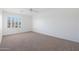 Bright and airy bedroom with neutral carpeting and large window with shutters at 7687 E Wing Shadow Rd, Scottsdale, AZ 85255