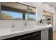 Modern kitchen sink with white countertop and stainless steel faucet at 7687 E Wing Shadow Rd, Scottsdale, AZ 85255