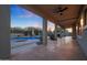 Covered patio overlooking pool, fenced backyard, and basketball court at 7687 E Wing Shadow Rd, Scottsdale, AZ 85255