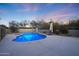 Inviting kidney-shaped pool with blue tile and a surrounding patio at 7687 E Wing Shadow Rd, Scottsdale, AZ 85255