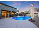 Blue illuminated pool with surrounding patio at 7687 E Wing Shadow Rd, Scottsdale, AZ 85255