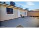 Backyard view showing patio, access door, and exterior of home at 8901 W Loma Ln, Peoria, AZ 85345