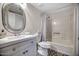 Clean bathroom with white vanity, oval mirror, and tub shower combo at 8901 W Loma Ln, Peoria, AZ 85345