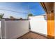 Private backyard with wooden gate and brick wall at 910 S Portland Cir, Mesa, AZ 85206