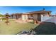 Spacious backyard with flagstone patio, fire pit, and mature landscaping at 910 S Portland Cir, Mesa, AZ 85206