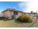 Backyard view of home with AC unit and flowering bushes at 910 S Portland Cir, Mesa, AZ 85206