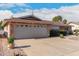 Brick ranch house with landscaped yard, two-car garage, and driveway at 910 S Portland Cir, Mesa, AZ 85206