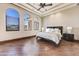 Spacious bedroom with hardwood floors and arched windows offering scenic views at 9108 N Fireridge Trl, Fountain Hills, AZ 85268