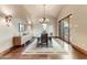 Formal dining room with hardwood floors, chandelier, and access to patio at 9108 N Fireridge Trl, Fountain Hills, AZ 85268