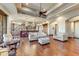 Open living room with hardwood floors, stone fireplace, and kitchen views at 9108 N Fireridge Trl, Fountain Hills, AZ 85268