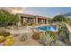 Inviting pool and spa with stone accents and desert landscaping at 9697 E Preserve Way, Scottsdale, AZ 85262