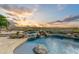 Resort-style pool and spa with waterfall and breathtaking sunset views at 9697 E Preserve Way, Scottsdale, AZ 85262