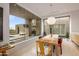 Elegant dining room with large windows and poolside access at 9821 E Sundance Trl, Scottsdale, AZ 85262