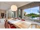 Light-filled dining area showcasing a wooden table and pool view at 9821 E Sundance Trl, Scottsdale, AZ 85262