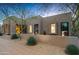 Desert landscape home with stucco walls and large windows at dusk at 9821 E Sundance Trl, Scottsdale, AZ 85262