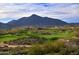 Expansive golf course surrounded by desert landscape and mountains at 9821 E Sundance Trl, Scottsdale, AZ 85262