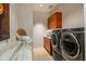 Modern laundry room with front-load washer and dryer at 9821 E Sundance Trl, Scottsdale, AZ 85262