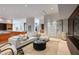 Bright living room with white sofa, modern coffee table, and large artwork at 9821 E Sundance Trl, Scottsdale, AZ 85262