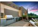 High-end stainless steel outdoor kitchen with built-in grill and refrigerator at 9821 E Sundance Trl, Scottsdale, AZ 85262