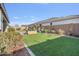 Landscaped backyard with artificial turf and brick pavers at 9925 E Orange Grove St, Florence, AZ 85132