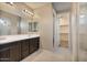 Modern bathroom with double vanity, dark cabinets, and a walk-in shower at 9925 E Orange Grove St, Florence, AZ 85132