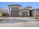 Two-story house with a three-car garage and landscaped front yard at 9925 E Orange Grove St, Florence, AZ 85132