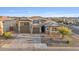 Two-story house with a three-car garage and landscaped front yard at 9925 E Orange Grove St, Florence, AZ 85132