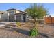 Two-story house with a three-car garage and landscaped front yard at 9925 E Orange Grove St, Florence, AZ 85132