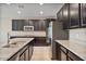 Modern kitchen with island, stainless steel appliances, and dark cabinetry at 9925 E Orange Grove St, Florence, AZ 85132