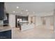 Modern kitchen with island, stainless steel appliances, and dark cabinetry at 9925 E Orange Grove St, Florence, AZ 85132