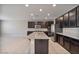 Modern kitchen with island, stainless steel appliances, and dark cabinetry at 9925 E Orange Grove St, Florence, AZ 85132