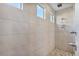 Large walk-in shower with hexagon tile flooring and multiple shower heads at 9925 E Orange Grove St, Florence, AZ 85132