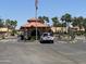 Gated community entrance with guardhouse and palm trees at 11111 E Elmhurst Dr, Sun Lakes, AZ 85248