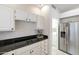 View of kitchen's cooktop, granite countertops, and access to laundry room at 11111 E Elmhurst Dr, Sun Lakes, AZ 85248