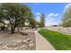 Landscaped pathway with mature trees and grassy areas at 11111 E Elmhurst Dr, Sun Lakes, AZ 85248